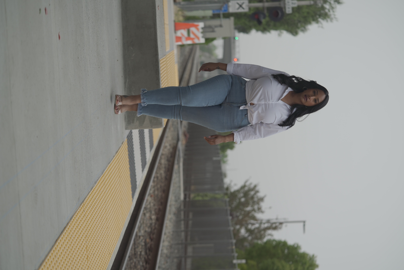 Portrait subject walking along a train platform during a lifestyle portrait session.