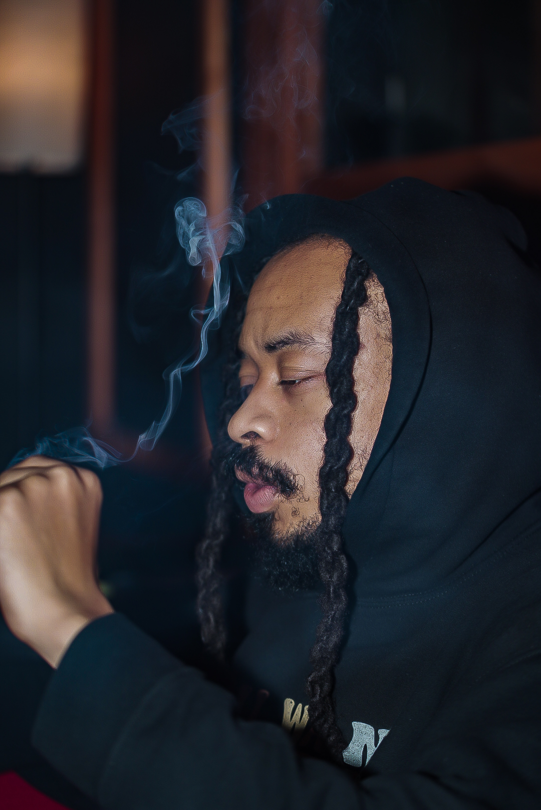 Lifestyle smoke portrait in a hoodie