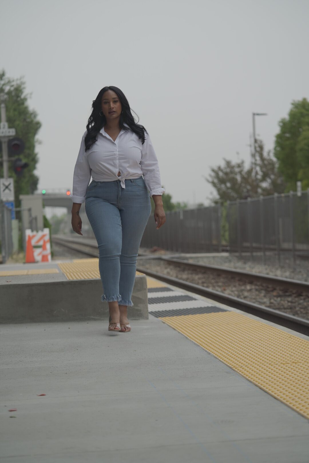 Portrait subject walking along a train platform during a lifestyle portrait session.